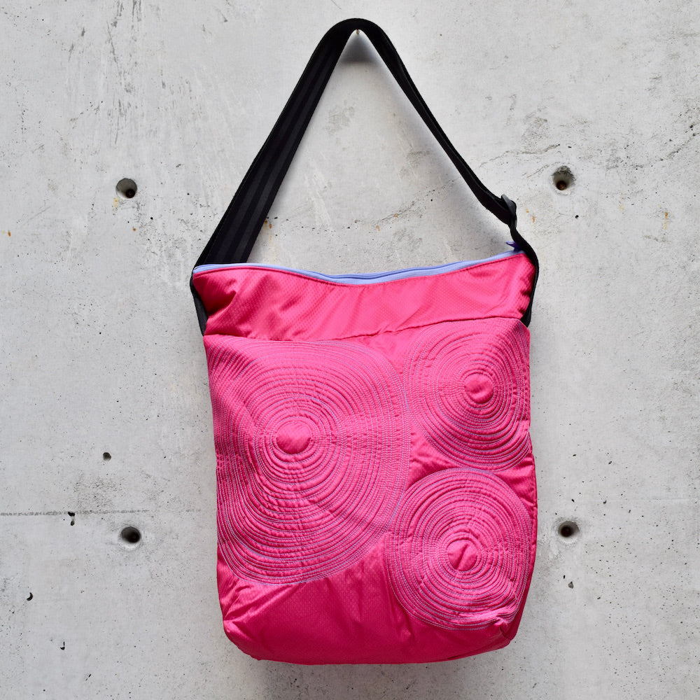 dinner bag, cross body bag. adjustable strap, 2 interior pockets, YKK zipper, made in canada, made in toronto, handmade one of a kind, topstitching, spirals, perfect for travel, perfect everyday, work, gym, play, travel, durable, lightweight and machine washable, hot pink with mauve stitching