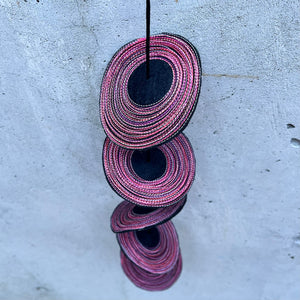 mobile: black felt with reds/pinks