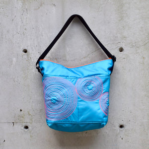 large zippered bag with outer pockets: teal with orange