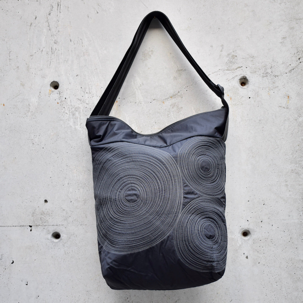 dinner bag, cross body bag. adjustable strap, 2 interior pockets, YKK zipper, made in canada, made in toronto, handmade one of a kind, topstitching, spirals, perfect for travel, perfect everyday, work, gym, play, travel, black with grey stitching, durable, lightweight and machine washable,
