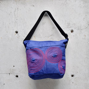 large zippered bag with outer pockets: purple with red