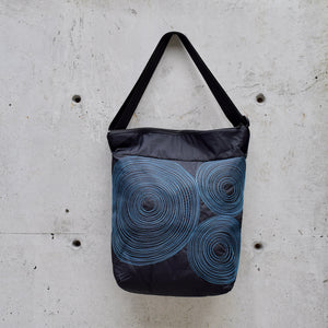 dinner bag, cross body bag. adjustable strap, 2 interior pockets, YKK zipper, made in canada, made in toronto, handmade one of a kind, topstitching, spirals, perfect for travel, perfect everyday, work, gym, play, travel, black with turquoise stitching, durable, lightweight and machine washable,