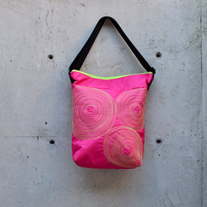 dinner bag, cross body bag. adjustable strap, 2 interior pockets, YKK zipper, made in canada, made in toronto, handmade one of a kind, topstitching, spirals, perfect for travel, perfect everyday, work, gym, play, travel, durable, lightweight and machine washable, hot pink with lime stitching